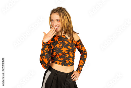 Young woman with dreadlocks smiling shyly covering mouth