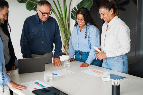 Multigenerational business people sharing ideas inside company office - Brainstorming and corporate concept - Main focus on african girl face - UGC content