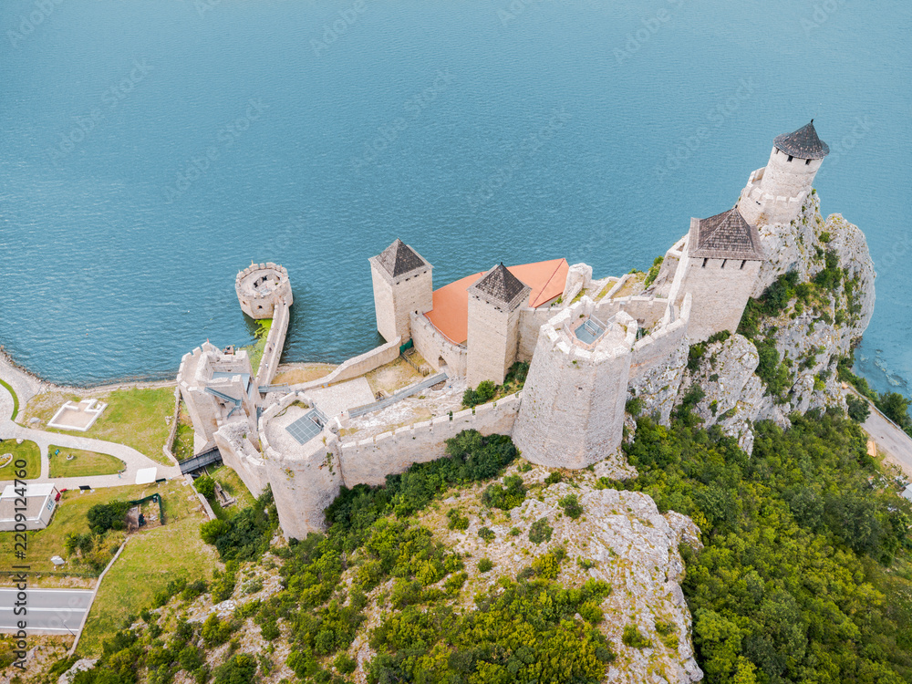 Fototapeta premium bird's-eye drone perspective reveals the full stone layout of Golubac Fortress jutting into the Danube