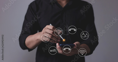 Young man hand using smartphone with to Interconnect, Interconnected Concept; People connect via wireless internet in a world of digital technology and communications that connect