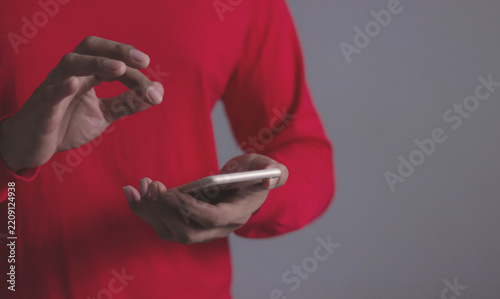 Young man using smartphone to select and interact with digital content for business.