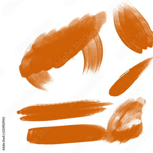 Orange watercolor brush strokes and paint smudges isolated on white background