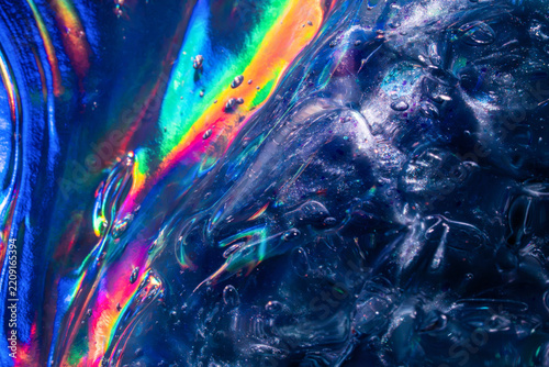 Iridescent rainbow light refract through textured ice