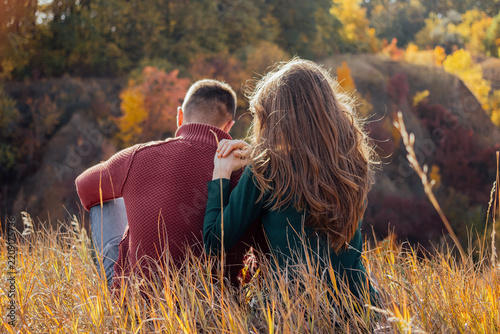 Couple sitting quietly in autumn forest setting