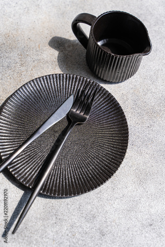 Black tableware set with mug, plate and cutlery