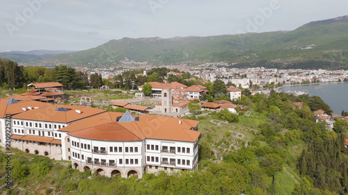 Aerial view of the Church of Saints Clement of Ohrid and Panteleimon with historic buildings, green hills, and Ohrid Lake, Ohrid, Municipality of Ohrid, North Macedonia.