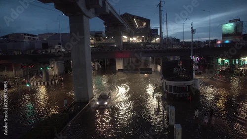 Street intersection covered with floodwater after heavy rain at night.