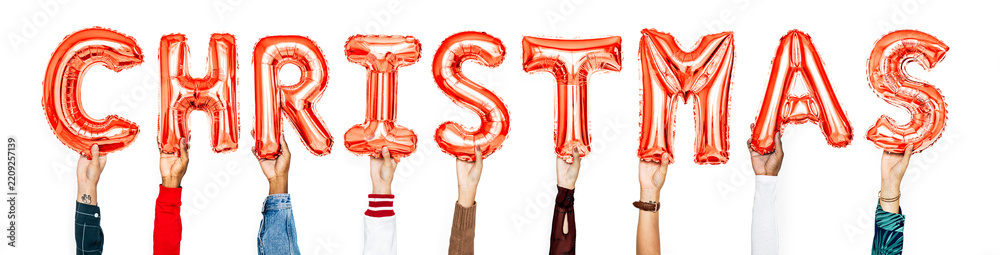 Obraz premium Hands holding balloons spelling Christmas
