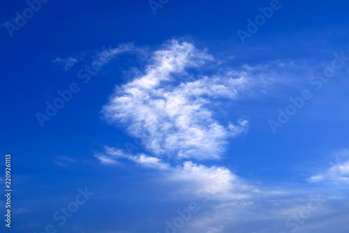 Blue sky with soft white clouds on clear day
