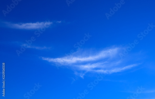 Blue sky with soft white clouds on clear day