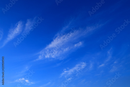Blue sky with soft white clouds on clear day