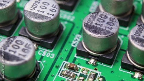 Part of an electronic printed circuit board with electronic components and connections, video macro shooting