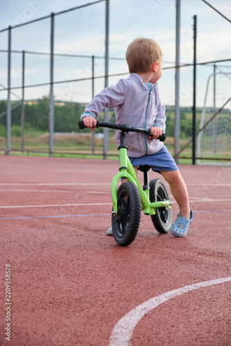 Little boy learn balance bike ride outdoor sport recreation leisure play