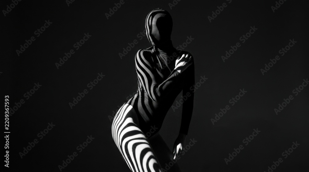 Fototapeta premium Abstract zebra-like stripes of hard light and shadow wrapping across a dark human form, monochrome conceptual photography, bold graphic contrast, sculptural curves, mysterious fashion and fine-art