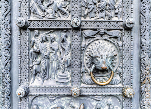 Intricate medieval relief carving depicting religious figures on ornate cathedral door, Bremen, Germany