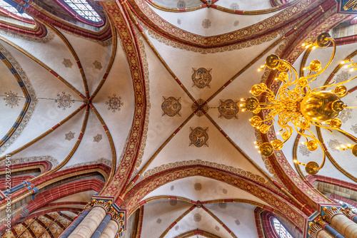 Gothic vaulted ceiling with chandelier inside Bremen cathedral.Germany