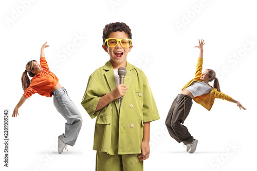 Kid singing and girls dancing in the back