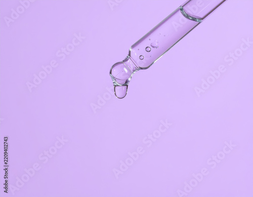 Dropper dispensing clear liquid cosmetic serum skincare drop