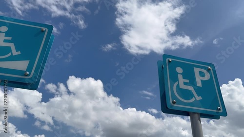 Left-to-right panning shot of an accessible parking area and wheelchair ramp.
