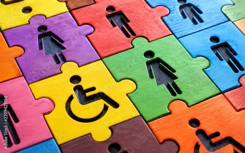 Colorful Wooden Puzzle Pieces with People and Wheelchair Icons Representing Diversity Inclusion and Accessibility