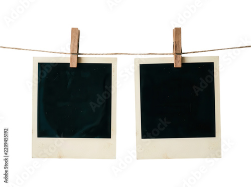 Two vintage polaroid instant frames hanging on string with clips