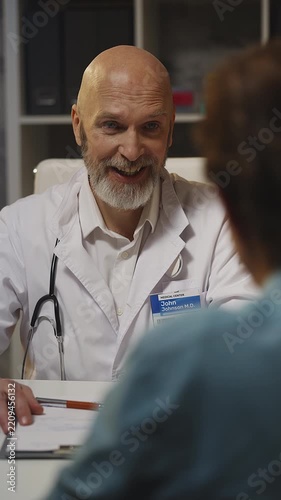 Smiling male doctor informs male patient about positive therapy results