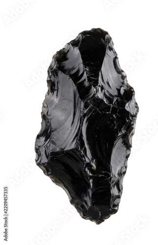 Handcrafted obsidian stone tool with sharp conchoidal fracture edges on a white background