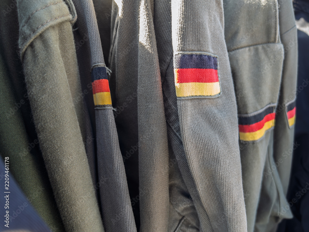Obraz premium Vintage German Military Uniforms Displayed for Sale