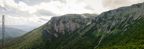 Sunlit Alpine Valley Surrounded by Rugged Limestone Cliffs, Green Slopes and Mountain Plateau in Rax Alps Austria