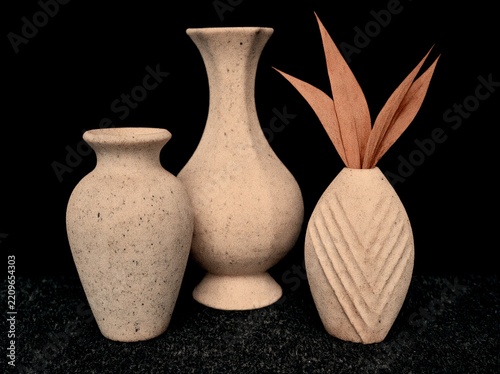 three vases, one with a faux plant