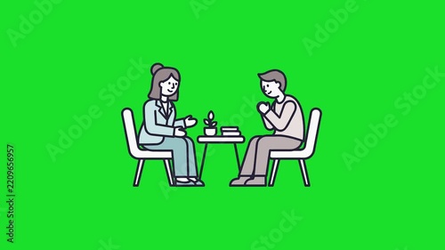Man and woman talking at a small table.