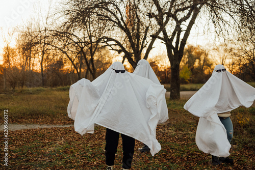 Fotografie People wearing ghost costumes in autumn park