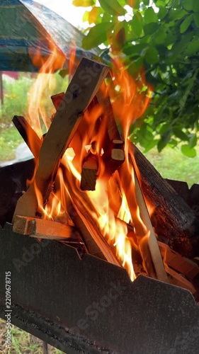 Close-up of burning firewood in a barbecue grill outdoors. High quality 4k footage