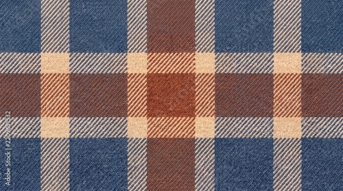 Classic blue brown and beige plaid wool fabric texture for warm autumn seasonal apparel