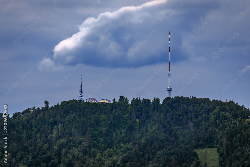 Obraz premium Uetliberg mountain television tower under dramatic clouds in Zurich, Switzerland