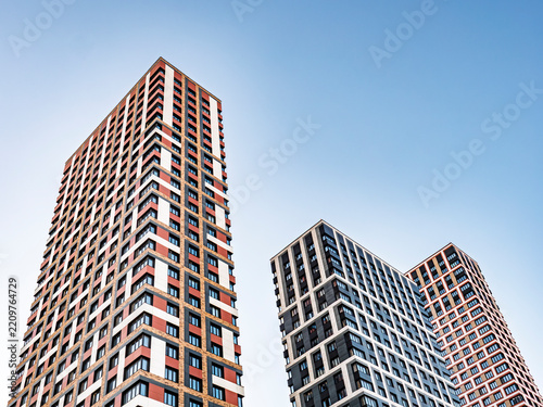 Modern high-rise residential apartment buildings against clear blue sky