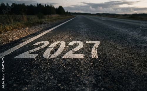 Road ahead painted with the year 2027 representing future planning, goals, and upcoming milestones in business and life