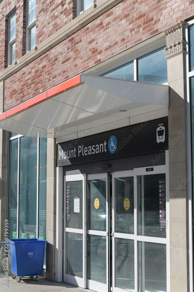 Fototapeta premium exterior building facade and sign of Mount Pleasant Station on Line 5 Eglinton located in midtown Toronto at the intersection of Eglinton Avenue East and Mount Pleasant Road