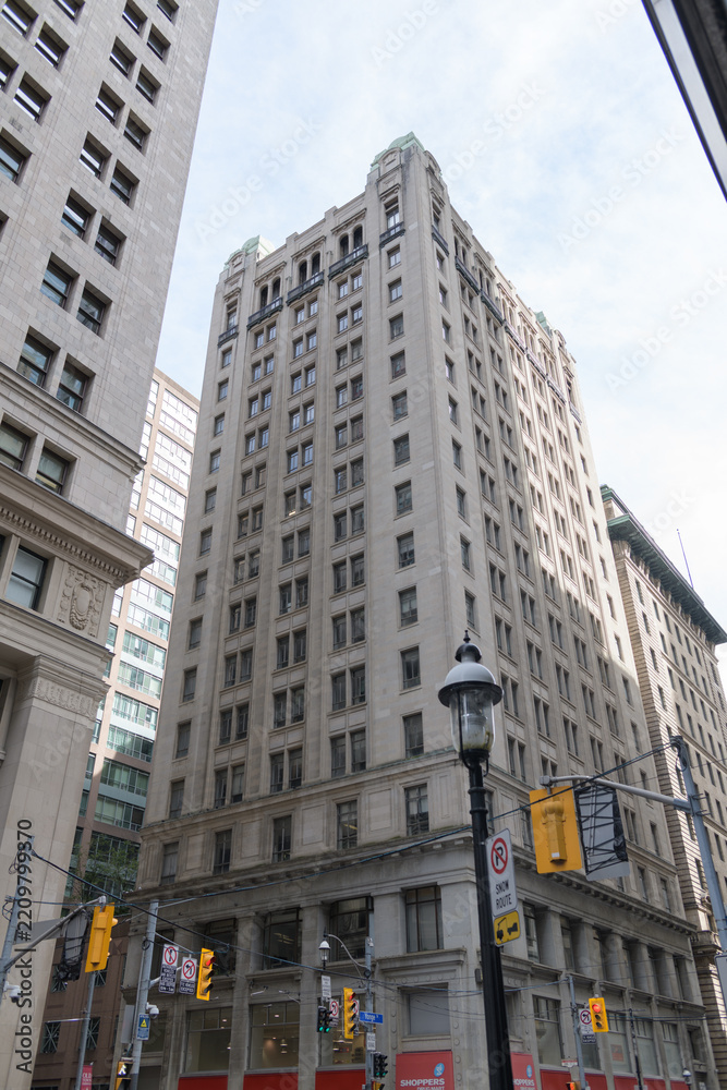 Fototapeta premium exterior building elevation of Canadian Pacific Building located at 69 Yonge St designed by Darling and Pearson, 1911-1913; site of a Shoppers Drug Mart, Toronto