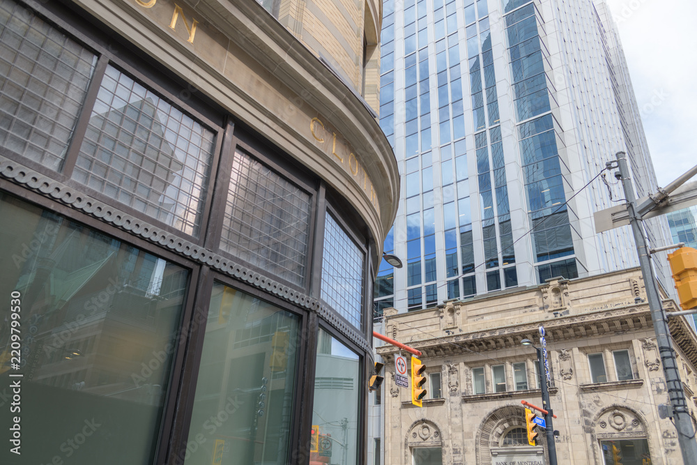 Obraz premium exterior of heavily restored Philip Jamieson Building (later known as FW Woolworth store) at 2 Queen St W, and 2 Queen Street East, an office tower with historic Bank of Montreal facade in Toronto 