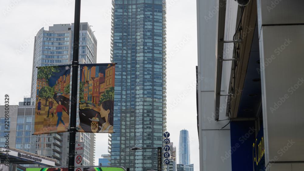 Obraz premium looking south on Yonge St from Sankofa Square to banners and north elevation of The Massey Tower, a condominium complex, Toronto