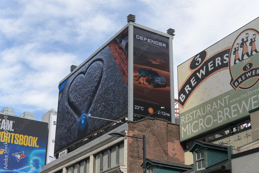 Obraz premium rooftop billboard featuring ads and store signs south of Sankofa Square (3 Brasseurs MicroBrewery, 275 Yonge St), Toronto