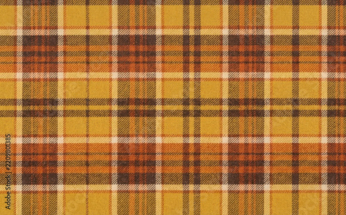Autumn plaid flannel fabric texture pattern background with warm mustard yellow orange and brown check design for cozy autumn and winter seasonal apparel projects