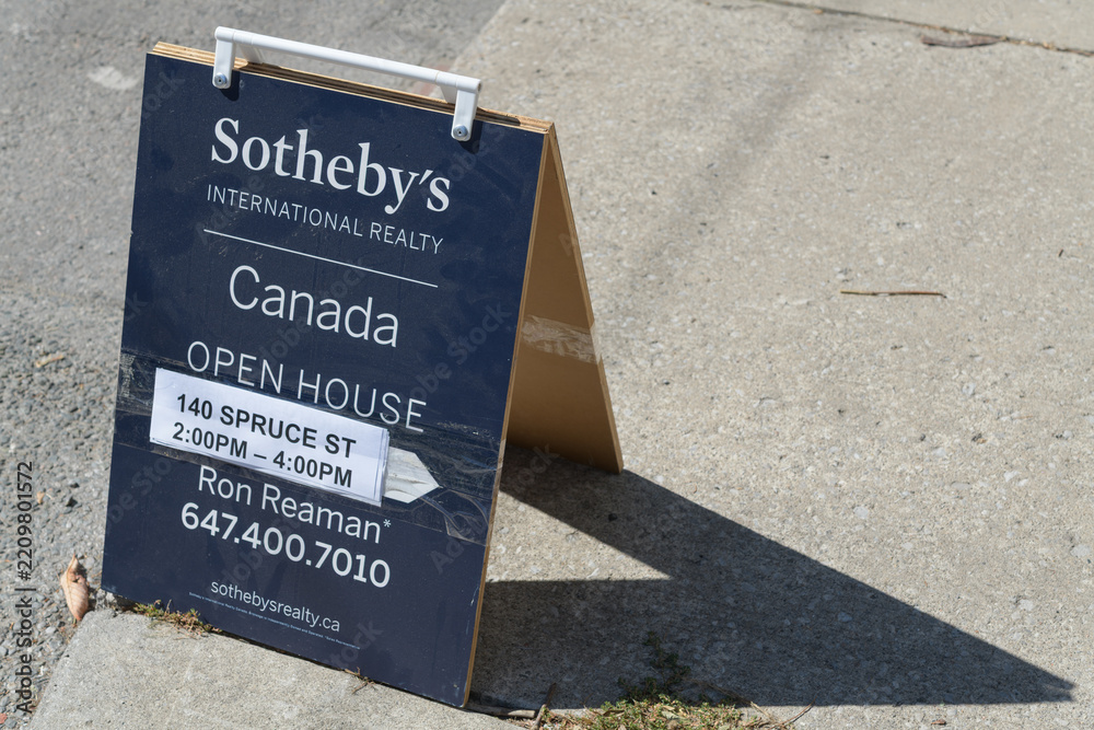 Obraz premium sidewalk a-frame sign of Sotheby's International Realty on Gerrard St E in Toronto