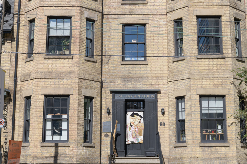 Fototapeta premium facade of a historic building and sign outside Gallery Arcturus located at 80 Gerrard St E, Toronto