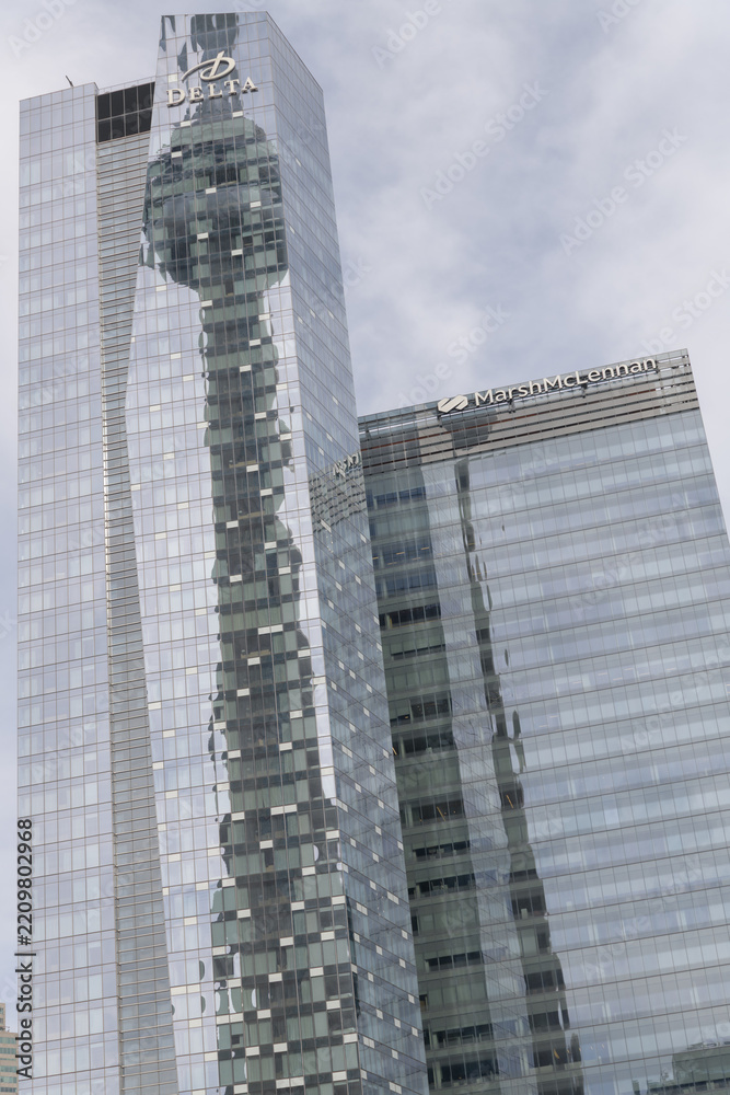 Fototapeta premium abstract reflection of landmark tower on the mirrored glass windows, west elevation of Delta hotel, 75 Lower Simcoe and Marsh/McLennan office tower in the Southcore Financial area, Toronto