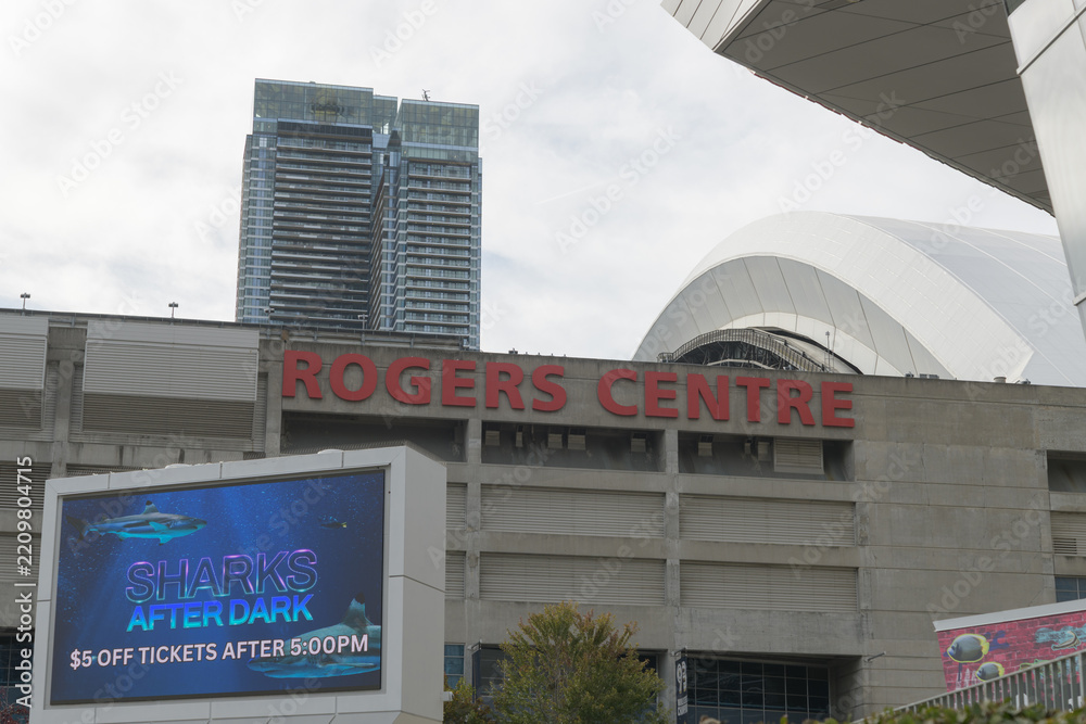 Fototapeta premium east elevation and sign at Rogers Centre, a stadium, with Ripley's Aquarium of Canada sign, Bremner Blvd, Toronto