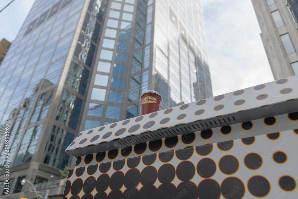 Fototapeta premium Tim Hortons coffee cup on a painted traffic control box in downtown Toronto