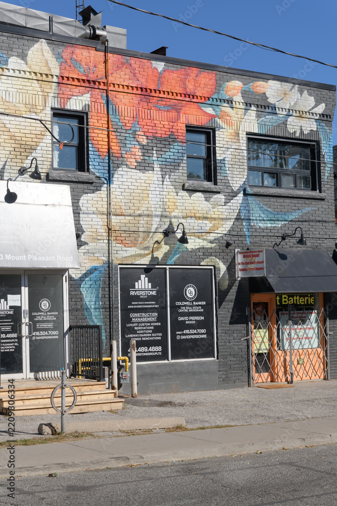 Fototapeta premium exterior building wall with floral mural and location of Riverstone Group Limited, a construction company, located at 693 Mount Pleasant Road, Toronto