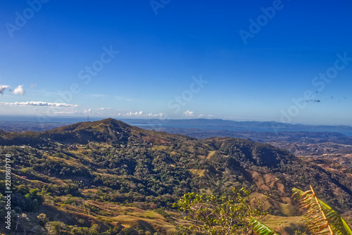 A beautiful tropical winter day with the distant lakes viewed from the top of a hill. Costa Rica